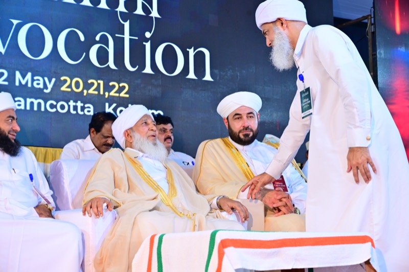 Senior scholars in conversation during the ceremony